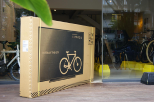 Photo of a VanMoof Bicycle packaged as a flat screen tv