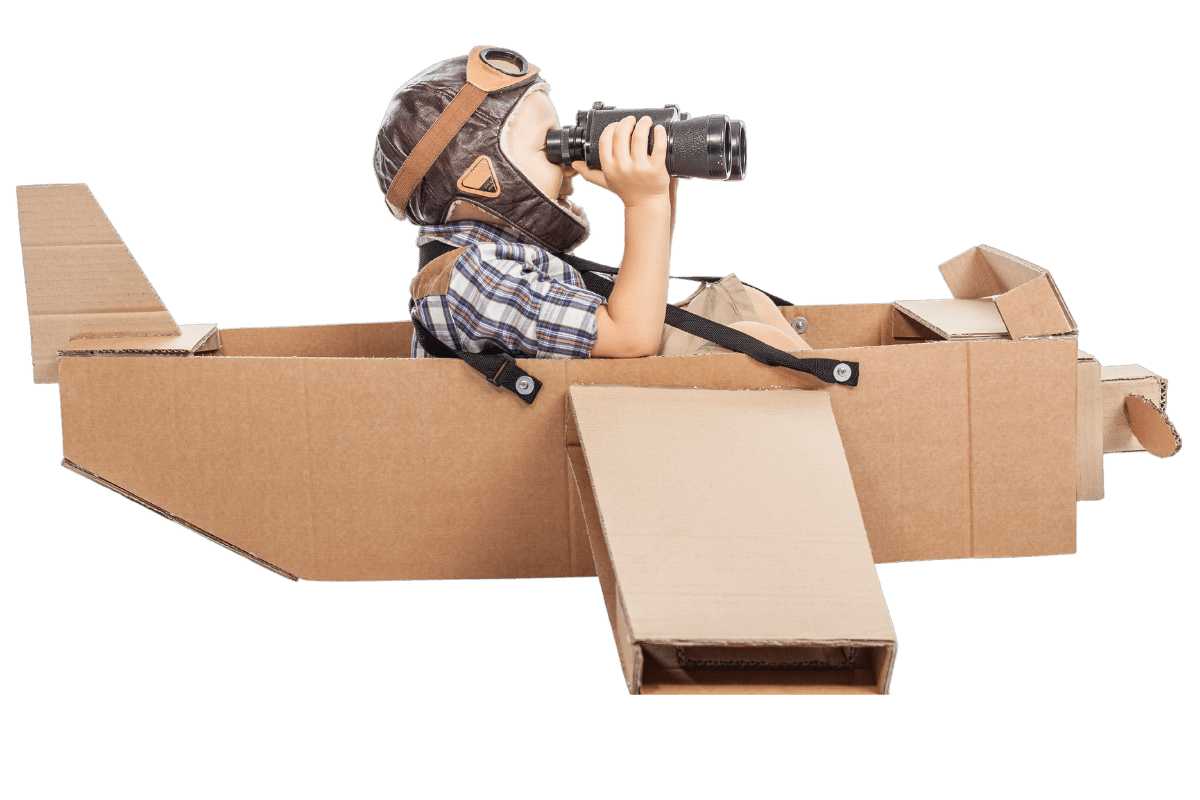 Young boy wearing aviator hat - using binoculars in cardboard plane